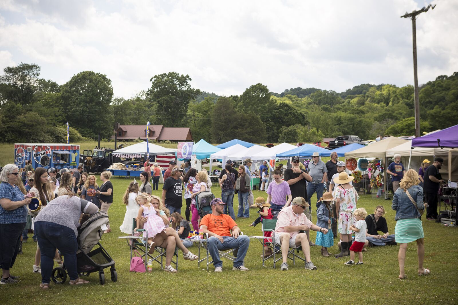 Families and neighbors gathered on the lawn at the Poke Sallet Festival