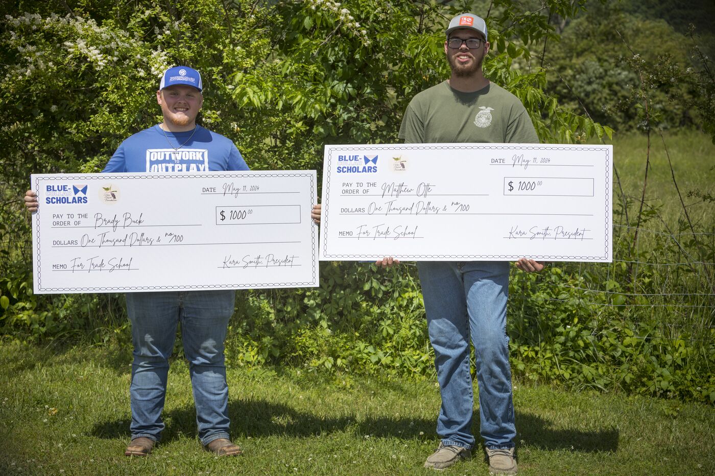 2024 Blue-Collar Scholars Brady Buck and Matthew Otte holding their scholarship checks